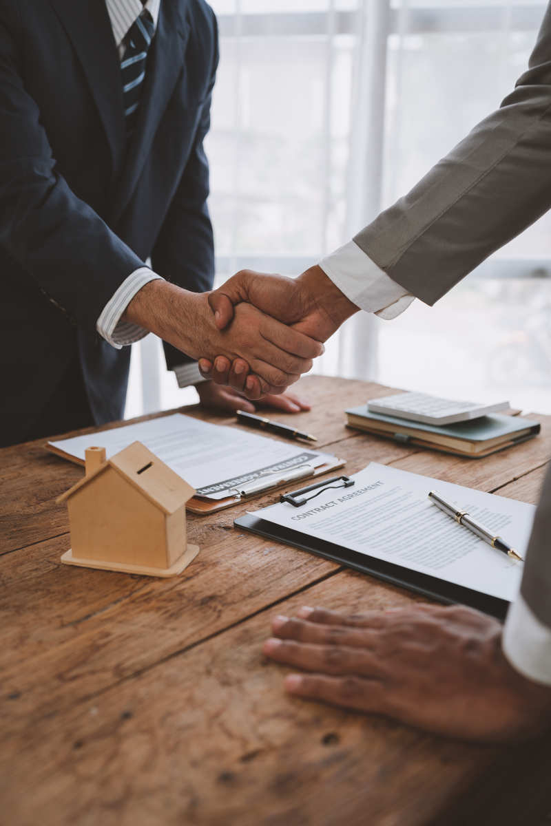 Handshake of real estate brokers with customers or investors, mo